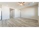 Spacious living room features wood-look tile flooring and a ceiling fan at 34865 N Palm Dr, San Tan Valley, AZ 85140