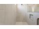 Shower featuring white tiling, mosaic tile floor, and built-in storage niche at 34865 N Palm Dr, San Tan Valley, AZ 85140