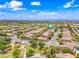 An aerial view displays the neighborhood and the home's location in relation to surrounding streets and landscaping at 3671 E Kingbird Pl, Chandler, AZ 85286
