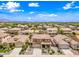 An elevated view of the home's location among many similar homes, with green landscaping and clear blue skies at 3671 E Kingbird Pl, Chandler, AZ 85286