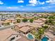 The aerial view shows the house's backyard, featuring a pool and palm trees, in relation to the wider neighborhood at 3671 E Kingbird Pl, Chandler, AZ 85286