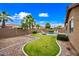Expansive backyard with a pool, green grass and mature trees offering a private outdoor oasis at 3671 E Kingbird Pl, Chandler, AZ 85286