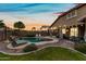 Private backyard features a sparkling pool, covered patio, and lush landscaping, ideal for outdoor living at 3671 E Kingbird Pl, Chandler, AZ 85286