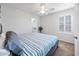 Bedroom featuring a ceiling fan, light-filtering shutters, a walk-in closet, and blue beddings at 3671 E Kingbird Pl, Chandler, AZ 85286