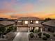 Two-story home with a red tile roof at sunset, showcasing desert landscaping and a spacious driveway at 3671 E Kingbird Pl, Chandler, AZ 85286