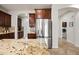 Spacious kitchen with stainless steel refrigerator, granite counters and custom cabinets at 3671 E Kingbird Pl, Chandler, AZ 85286