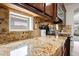 Granite counters and stainless appliances are highlighted in this kitchen at 3671 E Kingbird Pl, Chandler, AZ 85286