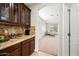 Kitchen nook with granite counter and custom cabinets that leads to living room at 3671 E Kingbird Pl, Chandler, AZ 85286