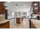 Open kitchen with granite countertops, stainless steel appliances, and a view of the living and dining areas at 3671 E Kingbird Pl, Chandler, AZ 85286