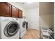 Laundry room featuring a white washer and dryer, cabinets, and wire shelving at 3671 E Kingbird Pl, Chandler, AZ 85286