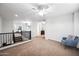Bright, open loft area features neutral tones, a ceiling fan, and a cozy reading nook for relaxation at 3671 E Kingbird Pl, Chandler, AZ 85286