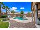 Beautiful backyard featuring a pool with rock waterfall and comfortable seating area at 3671 E Kingbird Pl, Chandler, AZ 85286