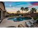 A lovely pool and spa area is complemented by lush landscaping and ambient string lights at 3671 E Kingbird Pl, Chandler, AZ 85286