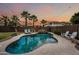 A serene backyard has a rock waterfall and refreshing pool perfect for relaxation and enjoyment at 3671 E Kingbird Pl, Chandler, AZ 85286