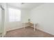 Bright bedroom showcasing neutral walls, carpeted flooring, and ample natural light at 45475 W Guilder Ave, Maricopa, AZ 85139