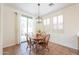 Cozy dining area with wood table and natural light from sliding glass door at 45475 W Guilder Ave, Maricopa, AZ 85139