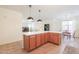 Open-concept kitchen featuring a breakfast bar and lots of cabinet space at 45475 W Guilder Ave, Maricopa, AZ 85139