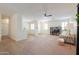 Open concept living area with tile and carpet flooring and neutral color scheme at 45475 W Guilder Ave, Maricopa, AZ 85139