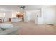 Bright living room that opens into the kitchen with stainless appliances at 45475 W Guilder Ave, Maricopa, AZ 85139