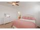 Bright main bedroom featuring neutral walls and a bed with colorful decorations and carpeted flooring at 45475 W Guilder Ave, Maricopa, AZ 85139