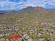 Aerial view of a desert community with sprawling homes and mountain views at 6714 E Amber Sun Dr, Scottsdale, AZ 85266