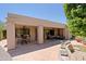 Expansive backyard showcasing the outdoor kitchen, serene water feature, and comfortable seating area at 6714 E Amber Sun Dr, Scottsdale, AZ 85266