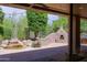 An outdoor kitchen complete with pizza oven and stone waterfall feature at 6714 E Amber Sun Dr, Scottsdale, AZ 85266