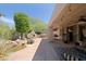 Beautiful backyard oasis with lush landscaping, custom outdoor kitchen and relaxing water feature at 6714 E Amber Sun Dr, Scottsdale, AZ 85266