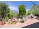 Beautiful backyard featuring lush landscaping, pond and custom pizza oven at 6714 E Amber Sun Dr, Scottsdale, AZ 85266