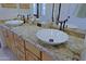 Bathroom vanity with double sinks, granite countertop, and wood cabinets at 6714 E Amber Sun Dr, Scottsdale, AZ 85266