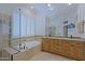 Bright bathroom with granite countertops, double sinks, soaking tub, and a seamless glass shower at 6714 E Amber Sun Dr, Scottsdale, AZ 85266