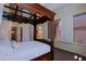 Spacious bedroom features a canopy bed frame, neutral walls, and bright windows at 6714 E Amber Sun Dr, Scottsdale, AZ 85266