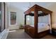 Bedroom boasts a four-poster bed, a ceiling fan, and a picturesque view of the outdoor scenery at 6714 E Amber Sun Dr, Scottsdale, AZ 85266