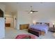 Spacious bedroom boasts neutral tones, plush carpet, ceiling fan, and natural wood furniture at 6714 E Amber Sun Dr, Scottsdale, AZ 85266