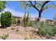 Single-story home featuring drought-resistant landscaping with boulders and cactus at 6714 E Amber Sun Dr, Scottsdale, AZ 85266