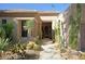Inviting home exterior featuring desert landscaping, a tiled roof, and a covered entryway at 6714 E Amber Sun Dr, Scottsdale, AZ 85266