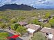 View of a beautiful home with a tile roof, desert landscaping, and mountain views at 6714 E Amber Sun Dr, Scottsdale, AZ 85266