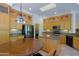 Bright kitchen with stainless steel appliances, granite counters, skylight, and custom cabinets at 6714 E Amber Sun Dr, Scottsdale, AZ 85266