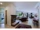 Spacious living room with stone fireplace and access to a backyard view at 6714 E Amber Sun Dr, Scottsdale, AZ 85266