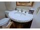 Stylish powder room featuring a stone sink, modern fixtures, and decorative accents at 6714 E Amber Sun Dr, Scottsdale, AZ 85266