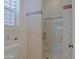 Shower featuring neutral tile, mosaic accents, and glass door at 6714 E Amber Sun Dr, Scottsdale, AZ 85266