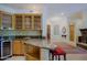 A classic wet bar features wood cabinets and a wine fridge at 6714 E Amber Sun Dr, Scottsdale, AZ 85266