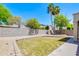 The yard features a green grass area, desert landscaping, and a block wall fence at 902 W Saragosa St, Chandler, AZ 85225