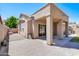 Paver stone patio leads to a backyard with a covered patio attached to an earth-toned single-story home at 902 W Saragosa St, Chandler, AZ 85225