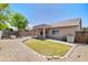 Charming backyard features a covered patio, grass, desert landscaping, and mature tree at 902 W Saragosa St, Chandler, AZ 85225