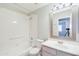 Full bathroom features tub, shower, vanity with mirror, and white tile at 902 W Saragosa St, Chandler, AZ 85225