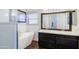 Bathroom features a soaking tub, dual sink vanity, and subway tile, creating a spa-like experience at 902 W Saragosa St, Chandler, AZ 85225