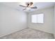 Neutral carpeted bedroom featuring a ceiling fan, window, and fresh, light paint at 902 W Saragosa St, Chandler, AZ 85225