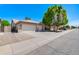 Single story home showcasing a beige exterior, desert landscaping, and a two-car garage at 902 W Saragosa St, Chandler, AZ 85225