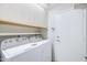 Functional laundry area featuring Whirlpool washer and dryer and upper cabinets at 902 W Saragosa St, Chandler, AZ 85225